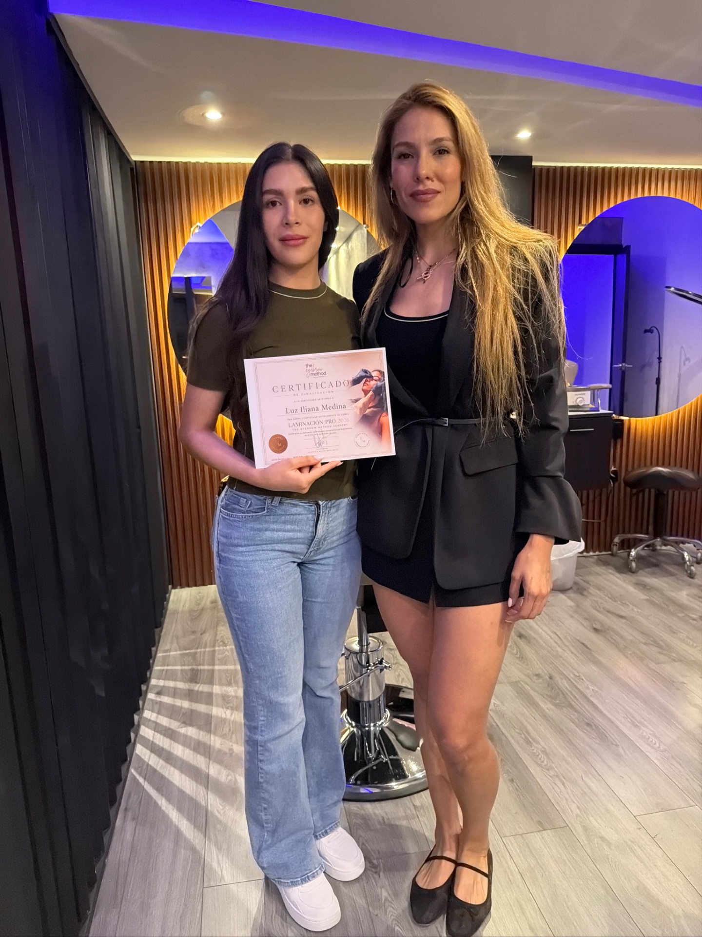 Makhy with a certified T/M Academy student holding her certificate