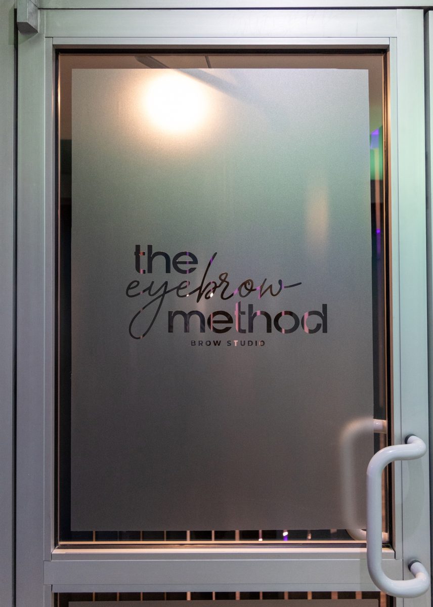The Eyebrow Method Brow Studio logo on a frosted glass door